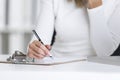 Close up of womanÃ¢â¬â¢s hand with a pen